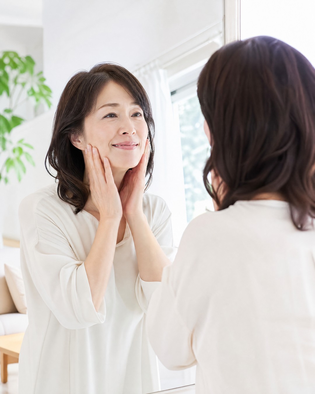 朝、明るい表情で鏡に向かう女性